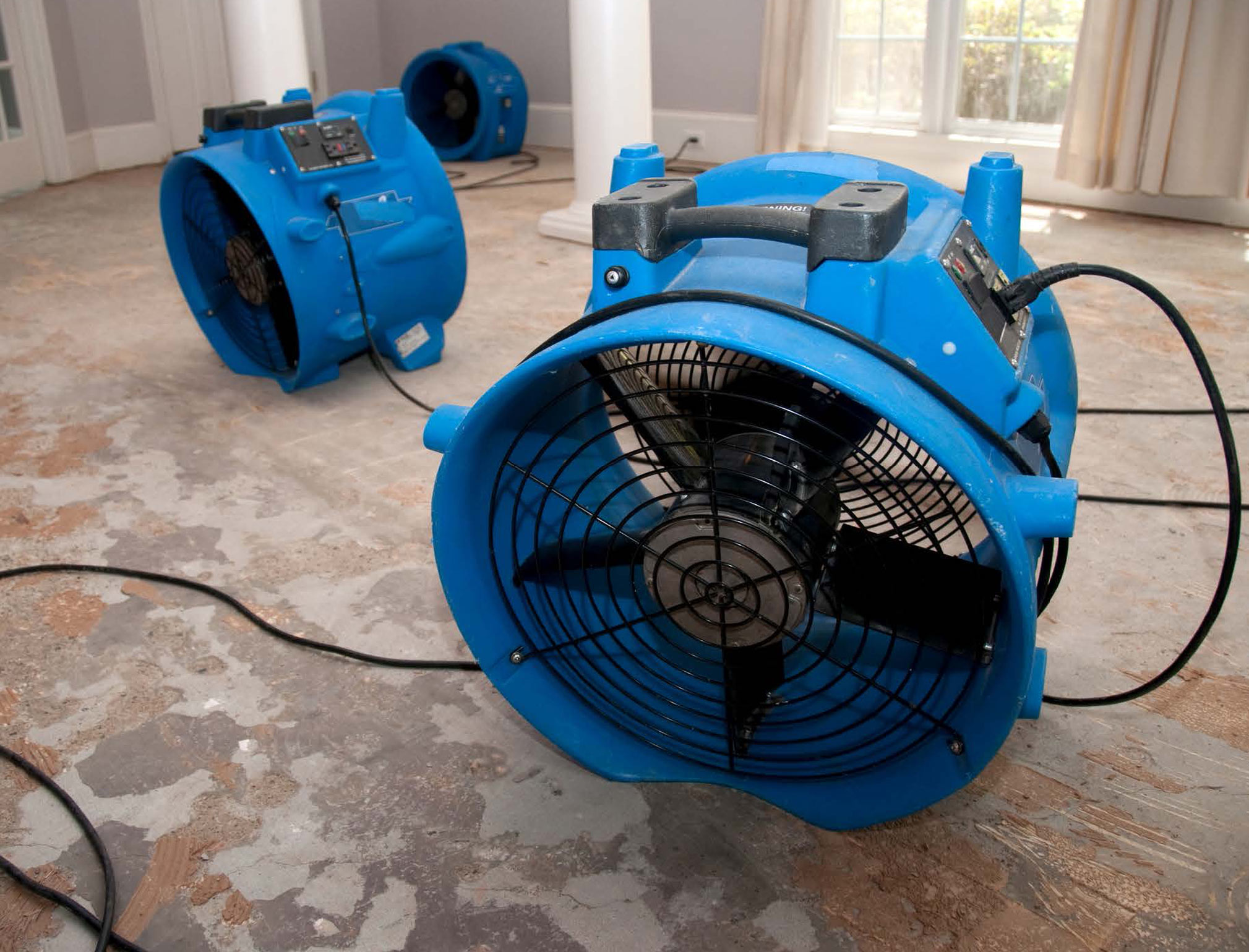 Huge blue commercial floor fans for debris and extreme moisture reduction